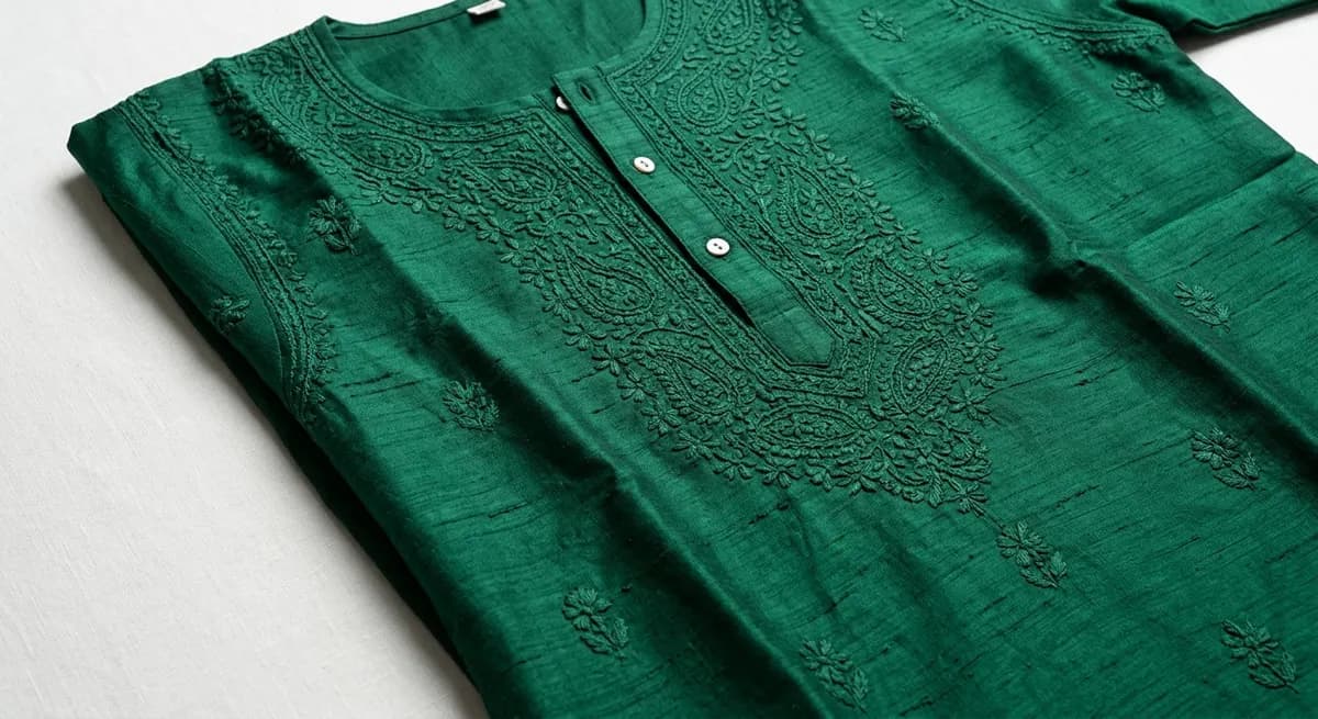 Close-up of emerald green kurta showing fabric weave, chikankari embroidery texture and garment structure — ShotRoom AI structural behavior intelligence